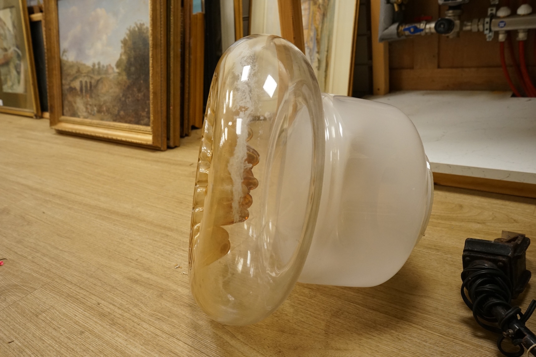 A large 1970's amber and opaque glass ceiling shade, 32cm high, Kandem model 802 adjustable lamp with clamp, 94cm high (fully extended) and a table lamp with toleware shade